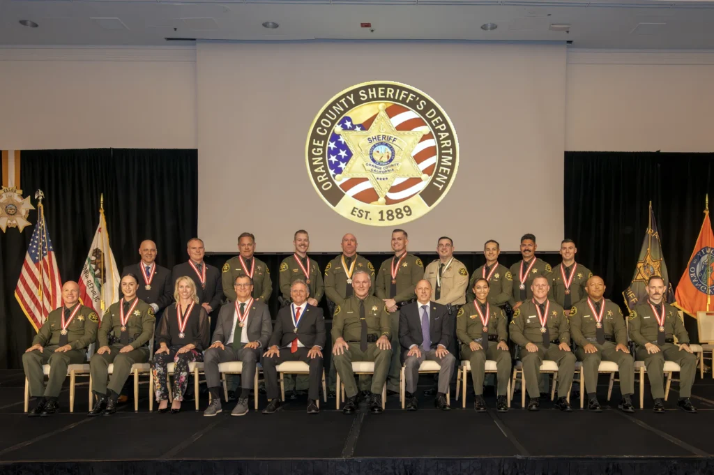 Medal of Valor 2026 honorees seated and standing on stage below the Orange County Sheriff’s Department seal